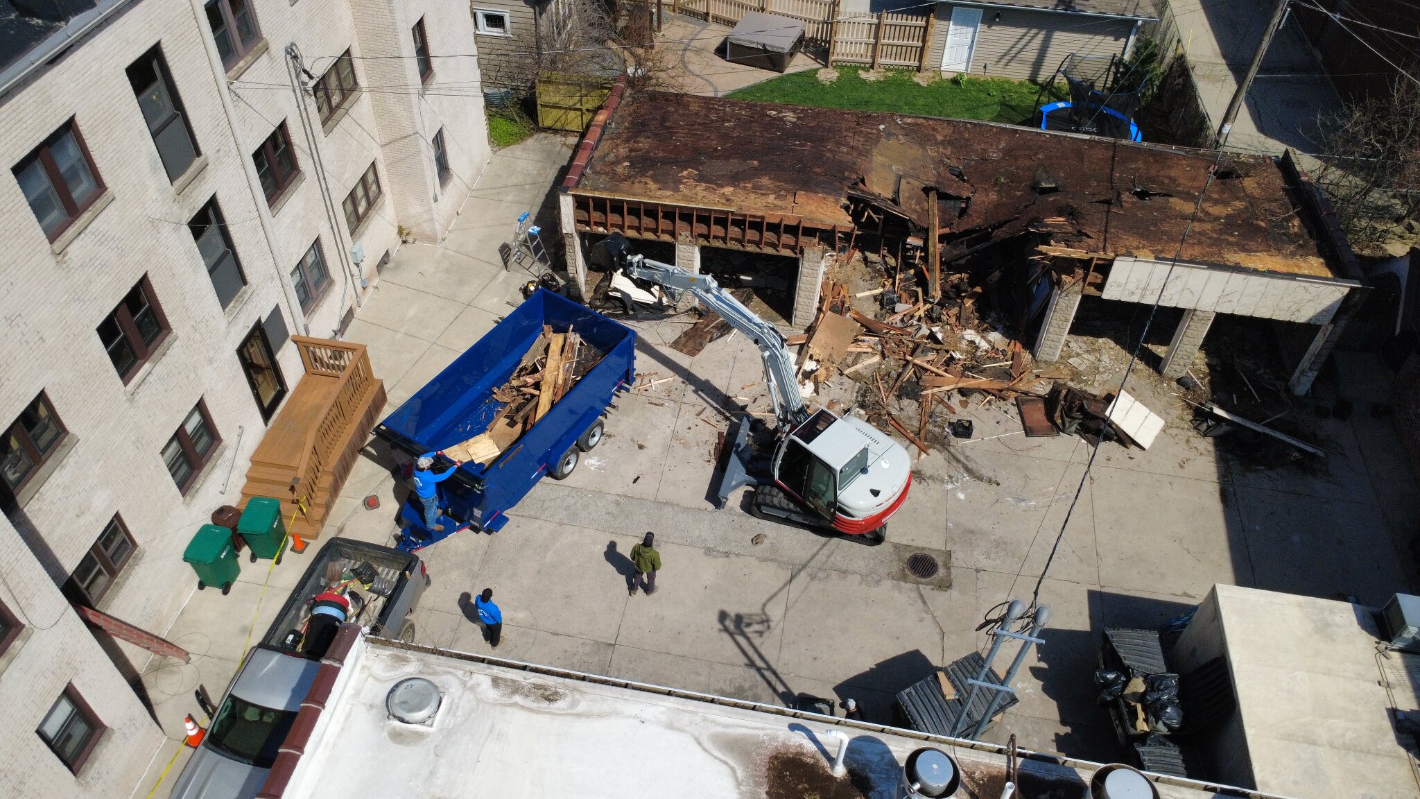 S&S Demolition removing a residential garage with an excavator